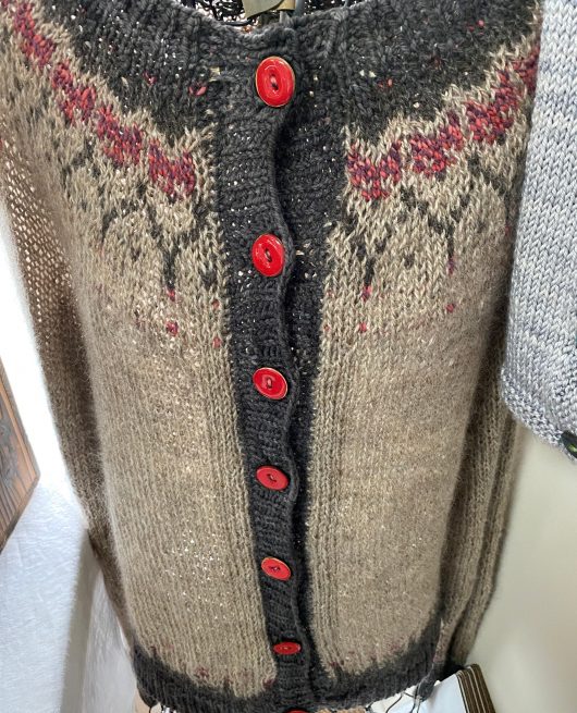 knit sweater with fox heads and red buttons