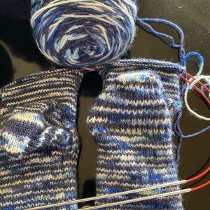 blue and white socks on the needle