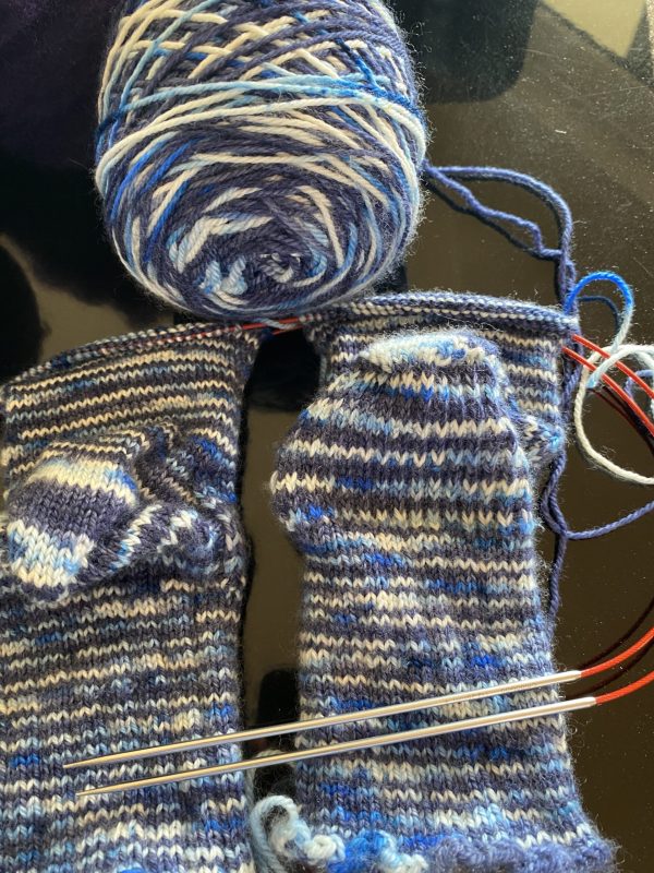blue and white socks on the needle