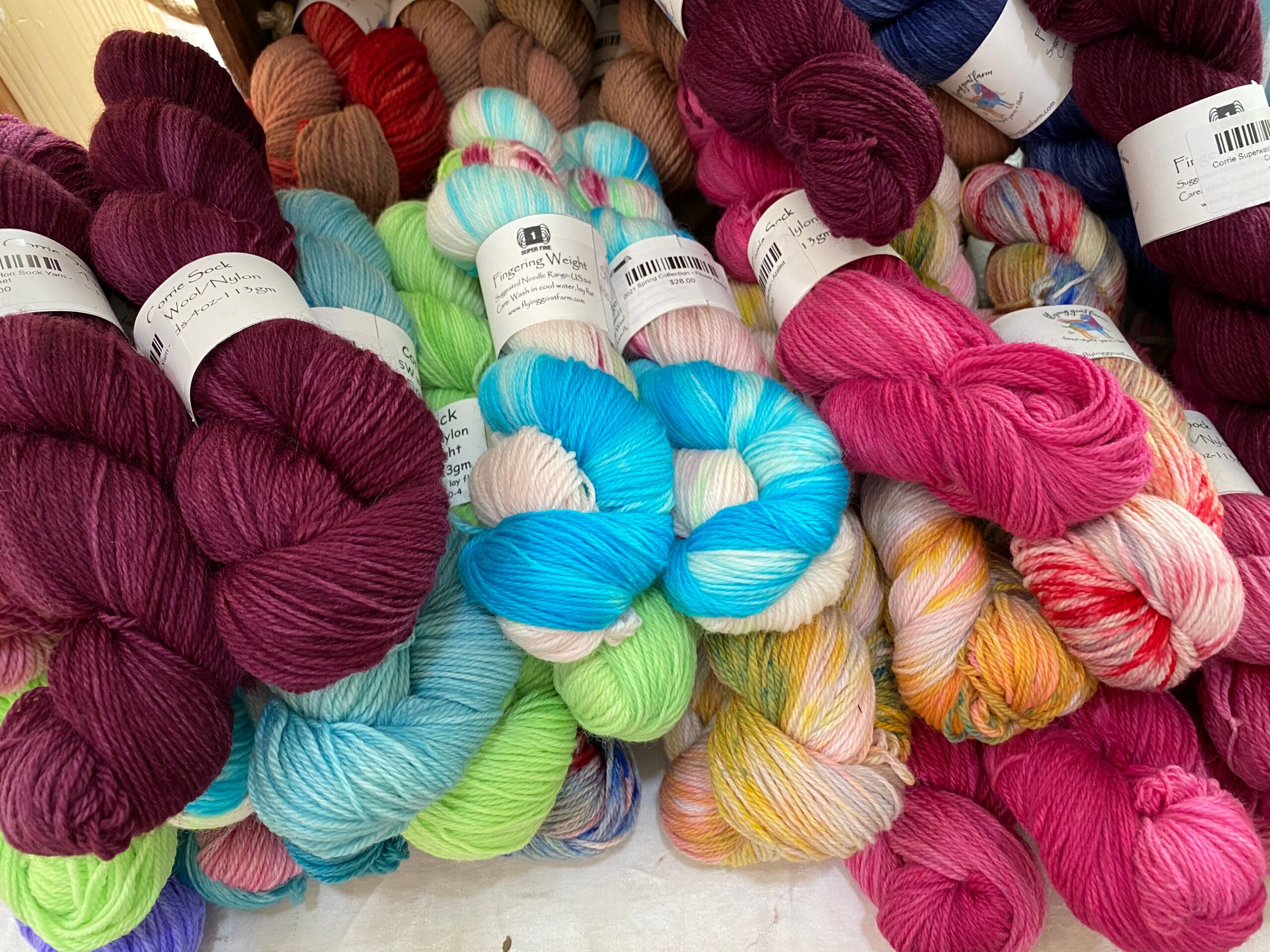 pile of multicolor fingering weight yarn