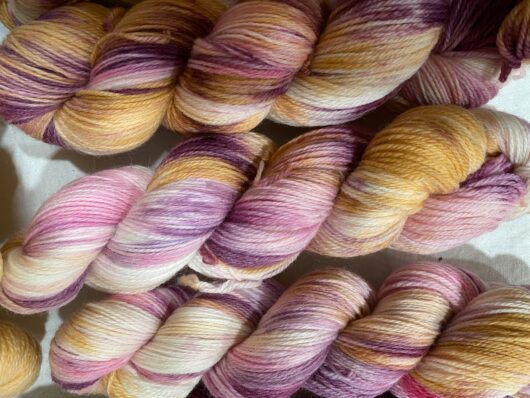 yarn skeins in apricot and raspberry
