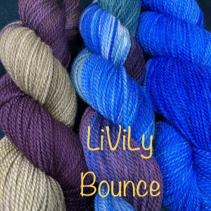 trio of wool skeins in blues, wine and green